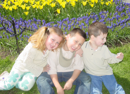 My three children together by the tulips